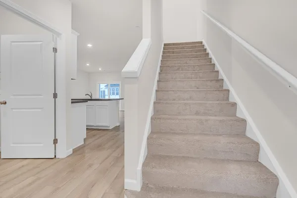 a view of entryway and hall with wooden floor