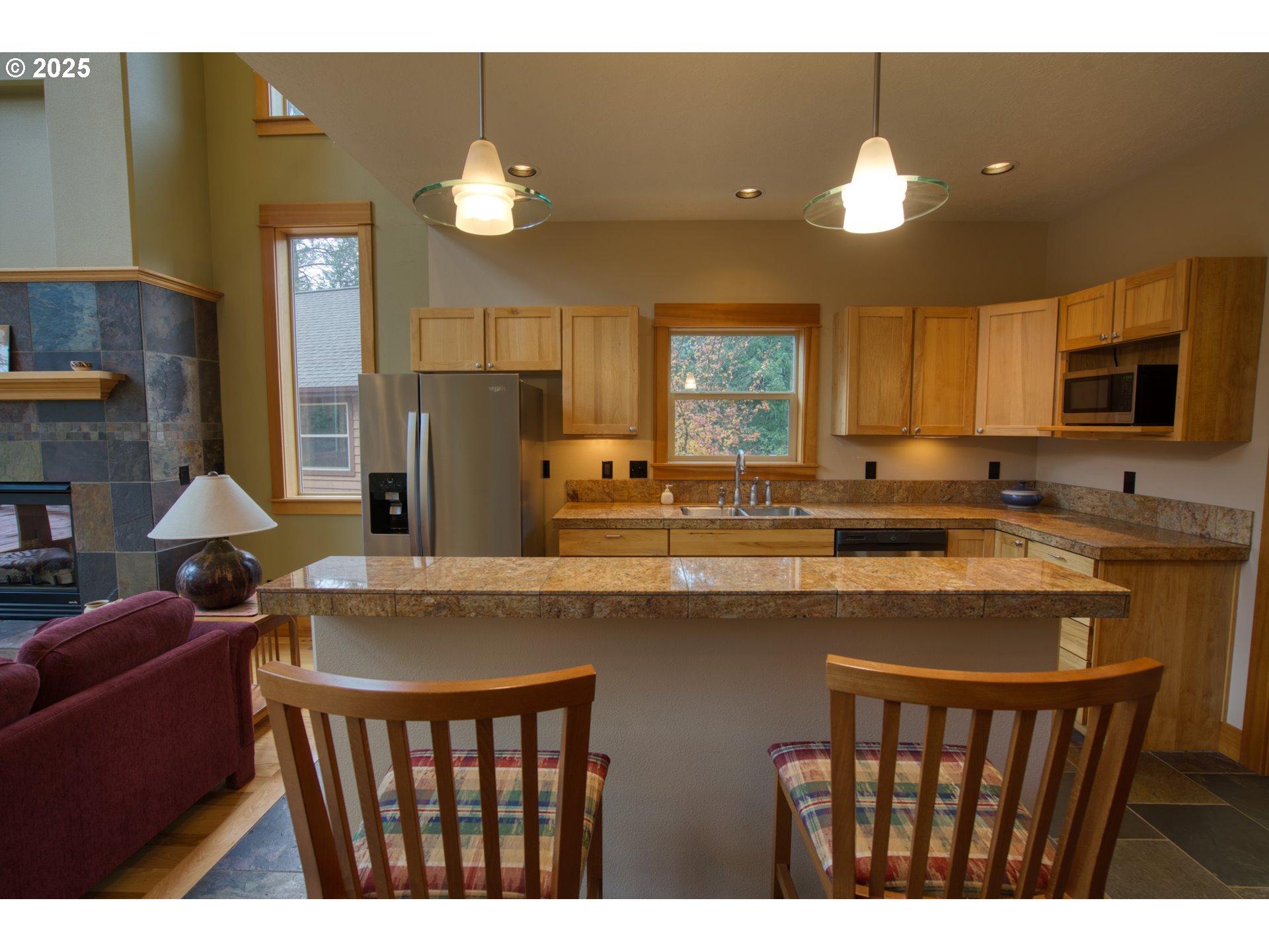 10 Emma Lane Trout Lake, WA 98650 - Photo 17 of 45 a kitchen with stainless steel appliances granite countertop a stove a sink a refrigerator and a dining table with wooden floor