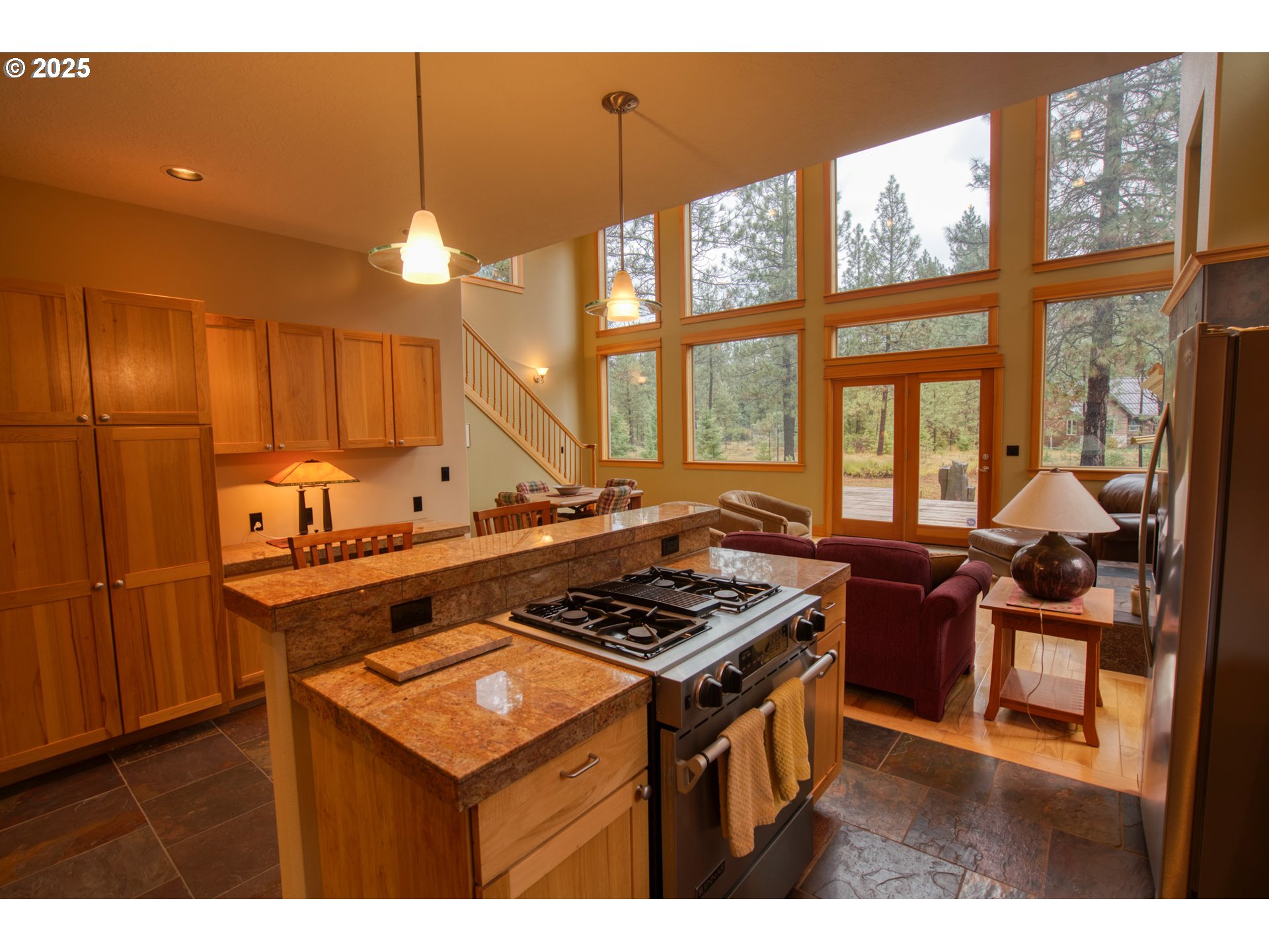 10 Emma Lane Trout Lake, WA 98650 - Photo 20 of 45 a kitchen with a stove a sink wooden floor and a dining table
