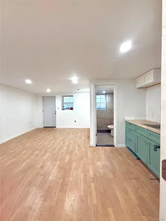 a big room with windows and cabinet