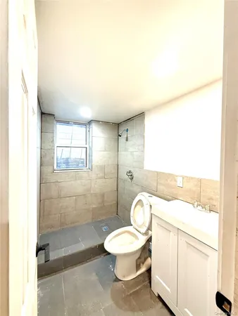 a bathroom with a toilet a sink and mirror