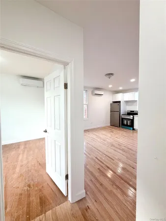 a view of a room with wooden floor and a cabinet