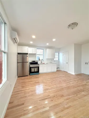 a view of kitchen with kitchen island wooden floor and window