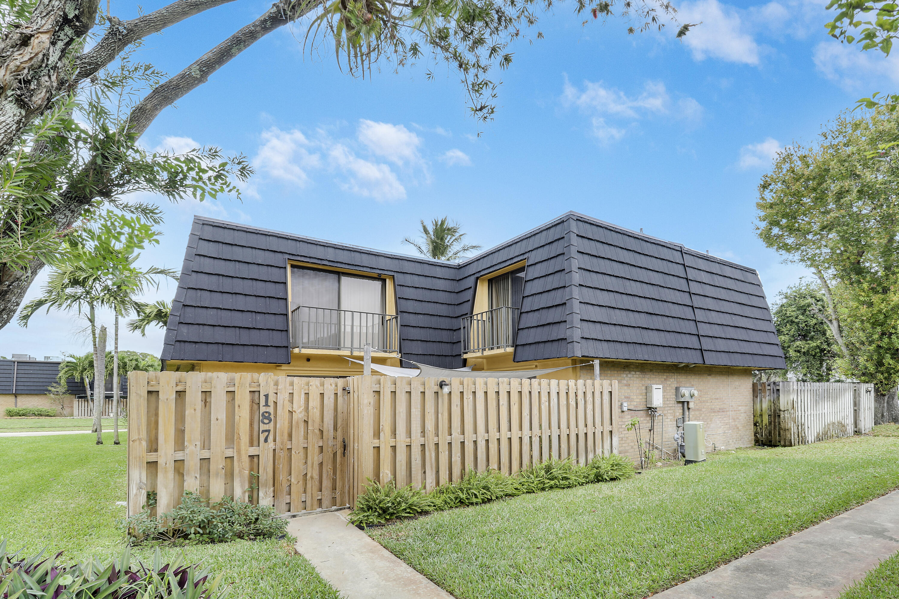 a front view of a house with a garden