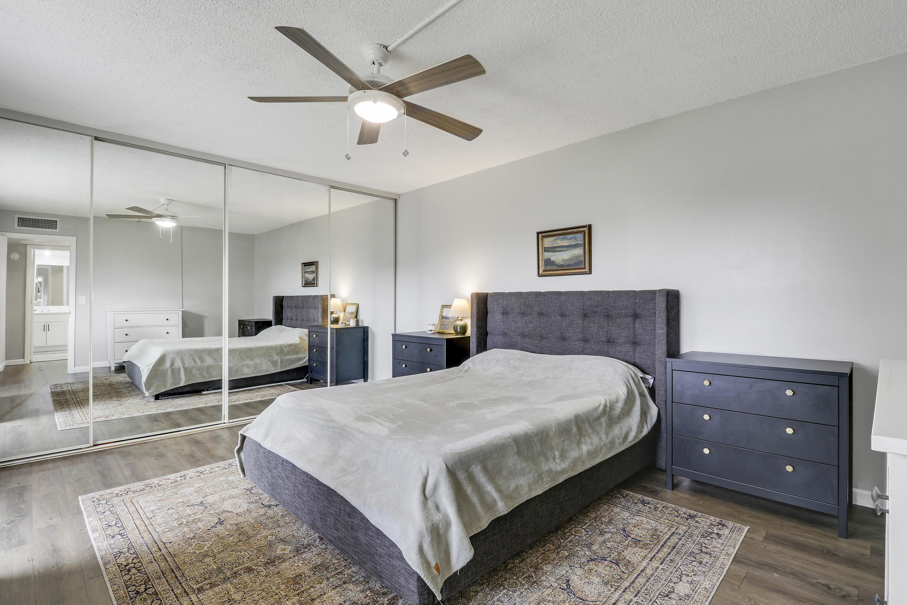 187 Woodland Road Palm Springs, FL 33461 - Photo 21 of 29 a spacious bedroom with a bed a window and couch