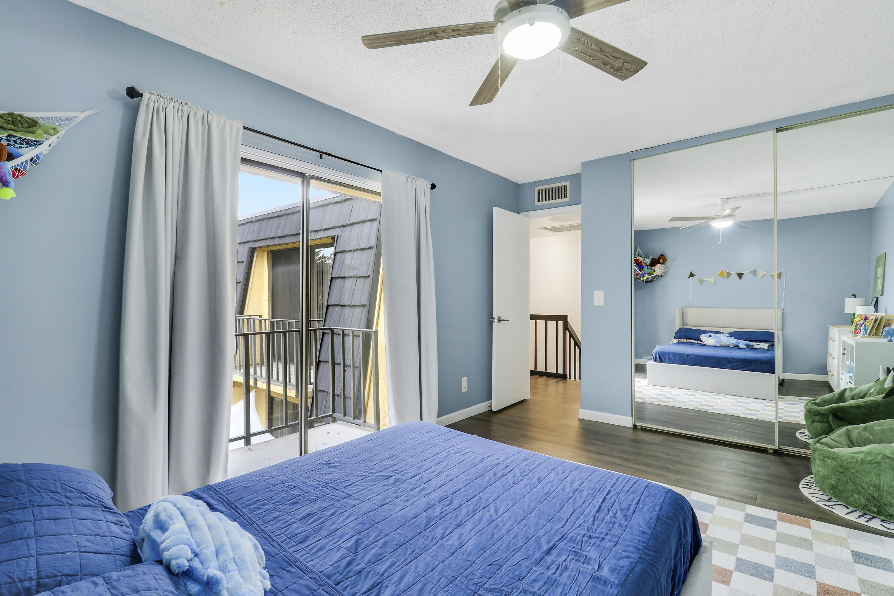 187 Woodland Road Palm Springs, FL 33461 - Photo 25 of 29 a bedroom with a bed and a large window