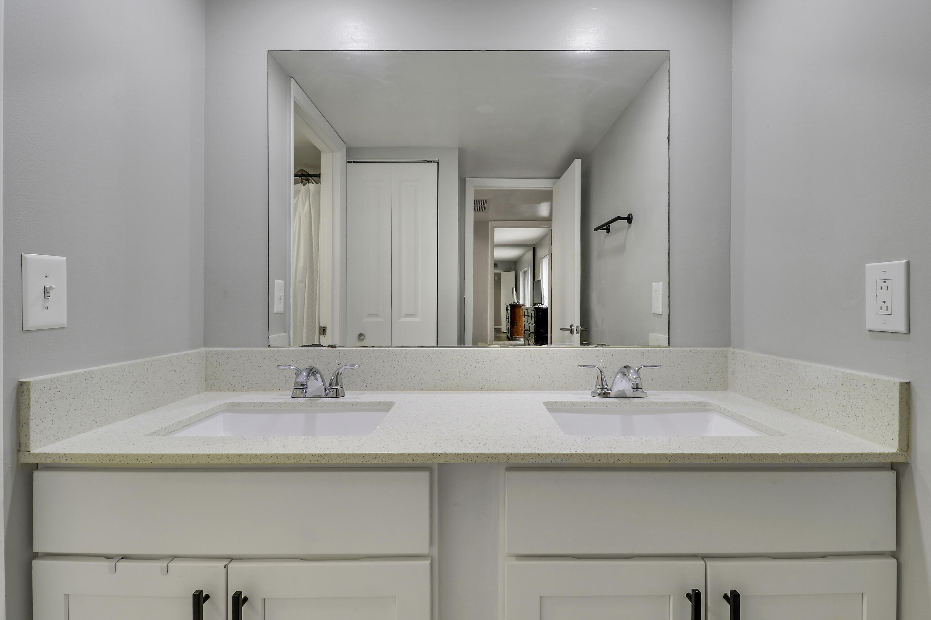187 Woodland Road Palm Springs, FL 33461 - Photo 26 of 29 a bathroom with double vanity sinks and a mirror