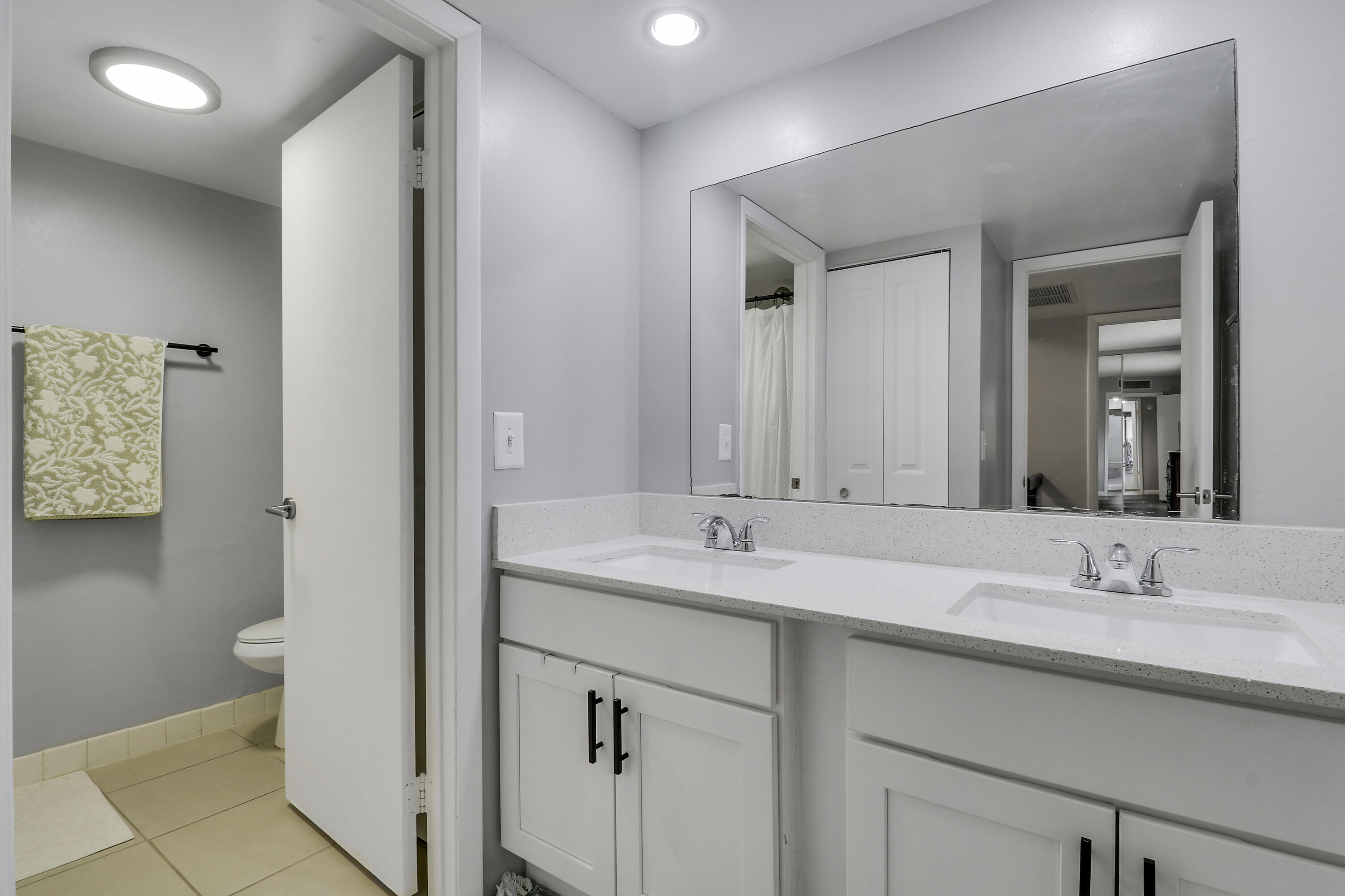 187 Woodland Road Palm Springs, FL 33461 - Photo 27 of 29 a bathroom with a sink and a mirror