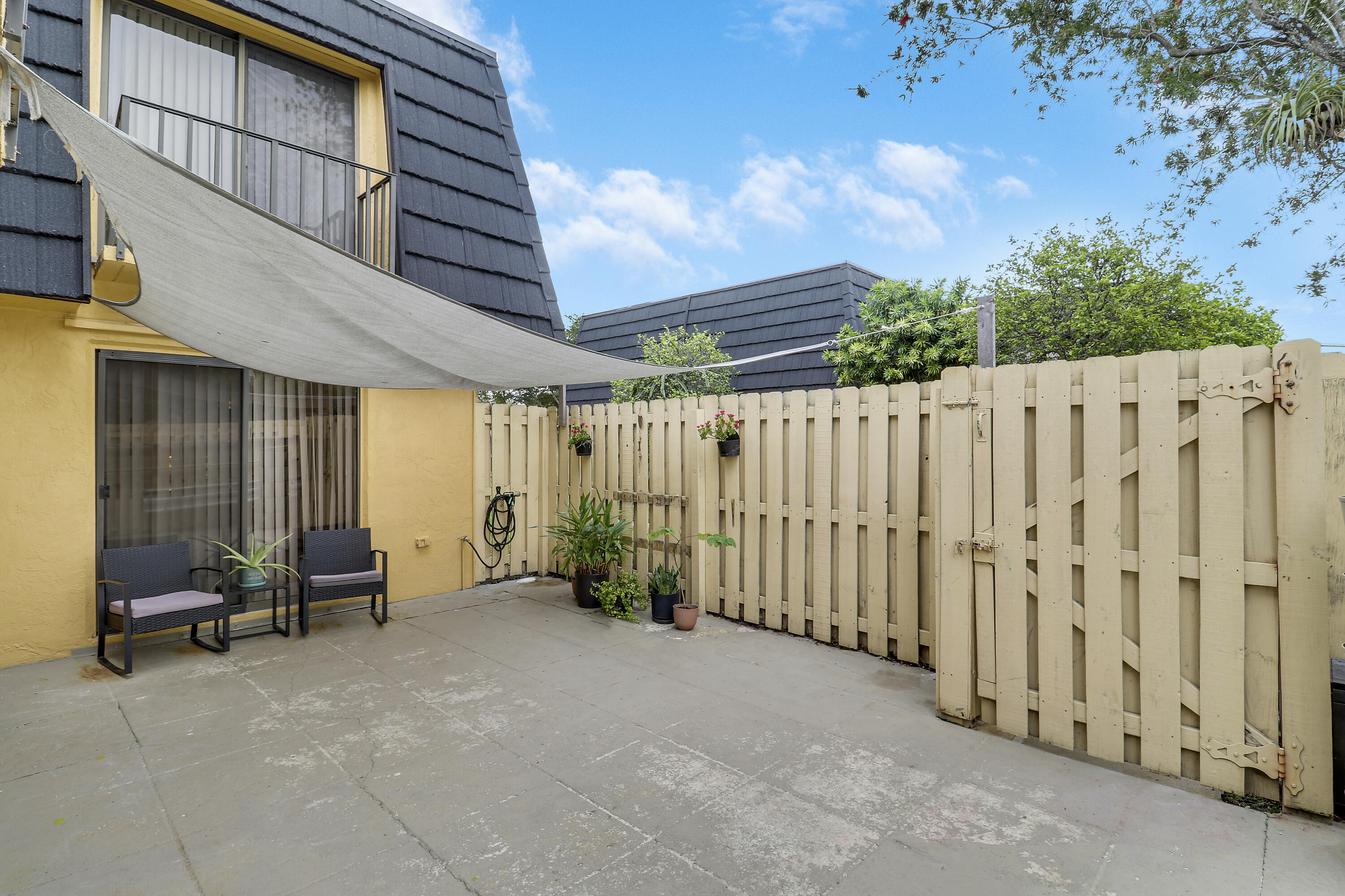 187 Woodland Road Palm Springs, FL 33461 - Photo 4 of 29 a view of a patio with a table and chairs