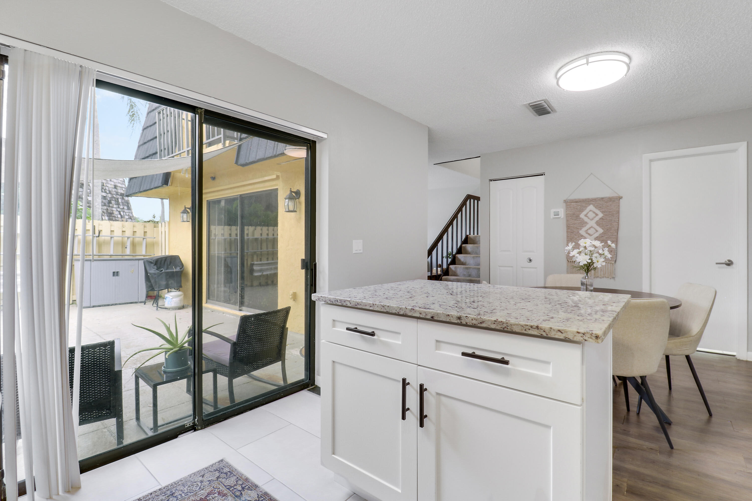 187 Woodland Road Palm Springs, FL 33461 - Photo 10 of 29 a bedroom with a granite countertop sink and a refrigerator