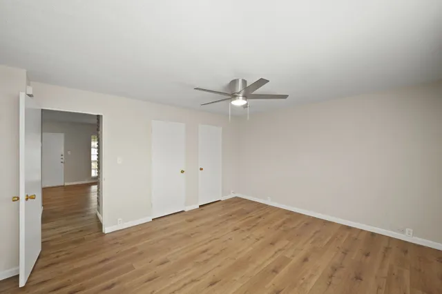 a view of a room with wooden floor