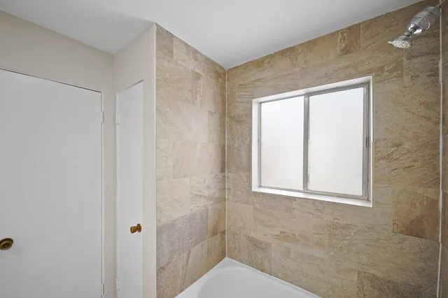 a bathroom with a shower and a toilet