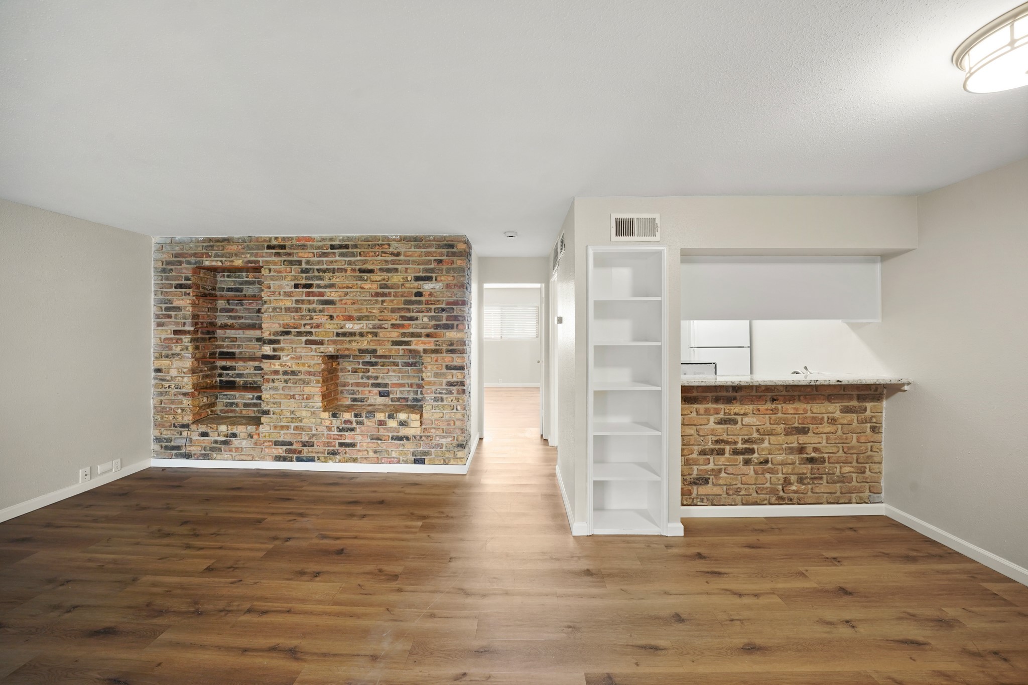 2201 Fountain View Drive, Unit 60F Houston, TX 77057 - Photo 3 of 18 a view of an empty room with wooden floor and a window