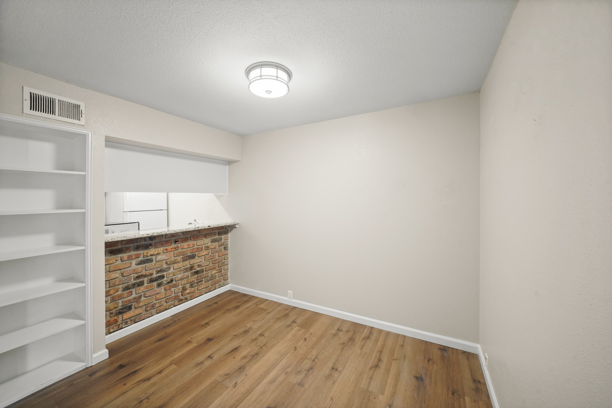 2201 Fountain View Drive, Unit 60F Houston, TX 77057 - Photo 5 of 18 a view of an empty room with cabinet and stairs