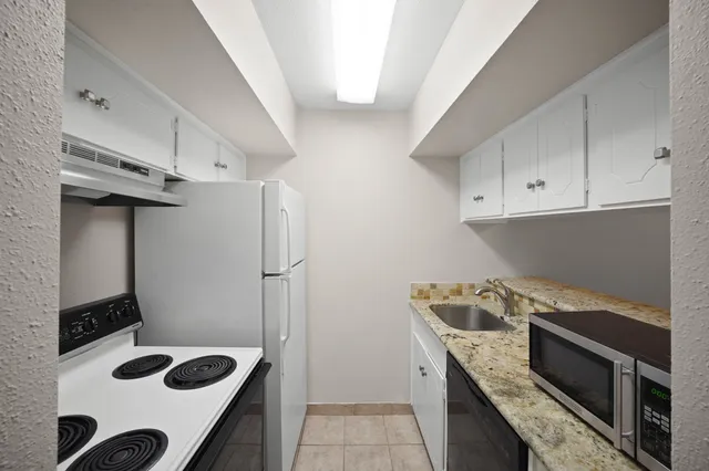 a kitchen with a stove and a refrigerator