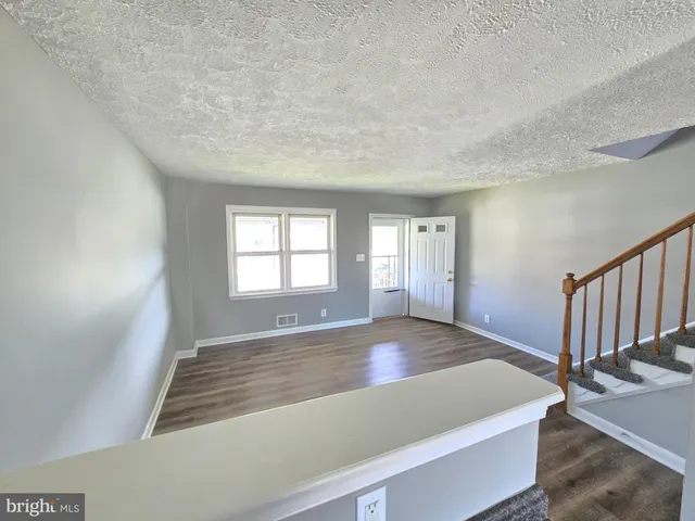 a view of wooden floor and windows in a room