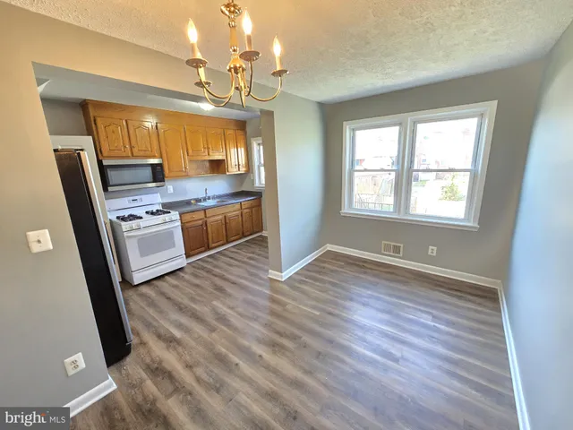 a view of kitchen and wooden floor