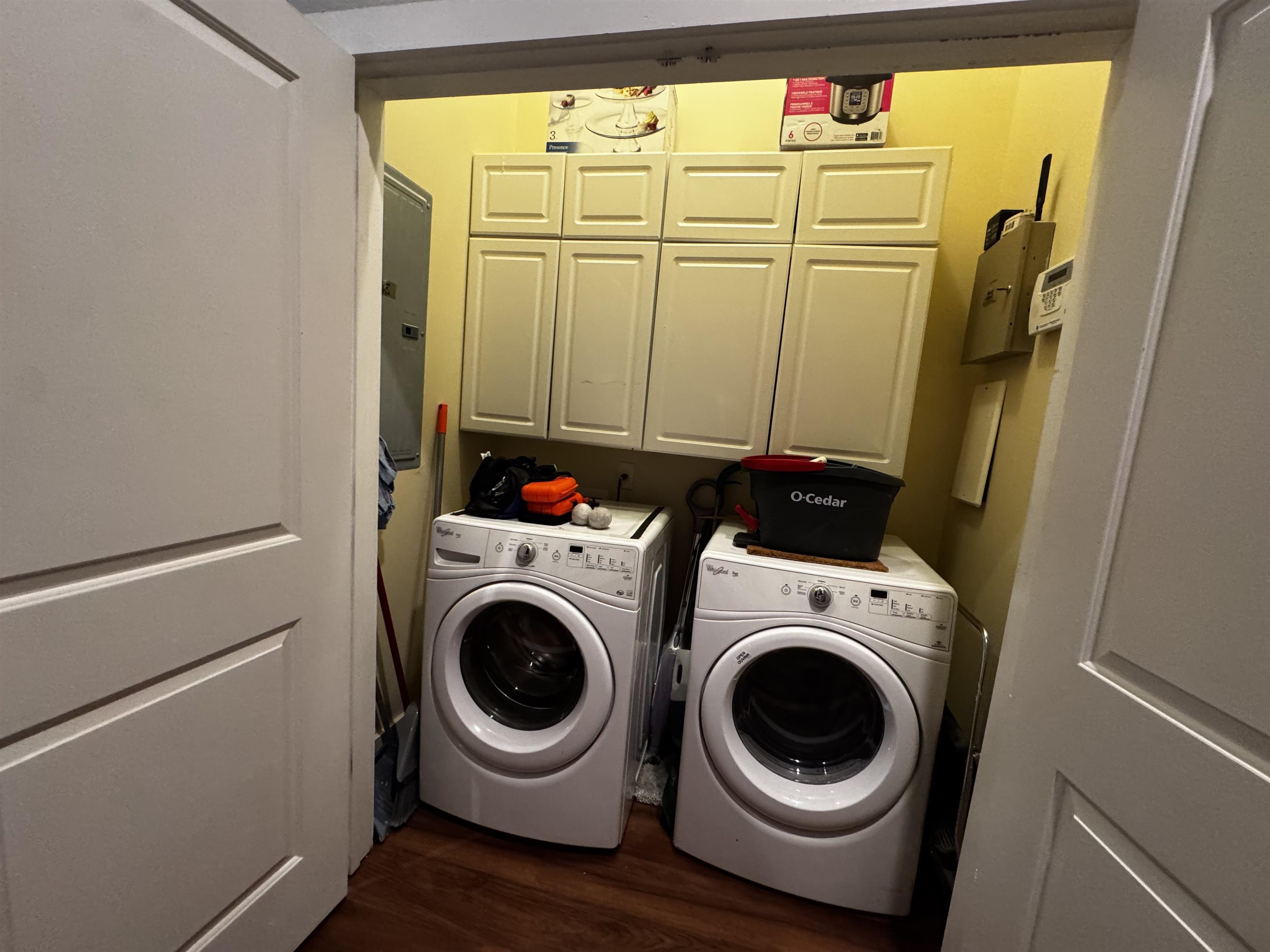 435 South Front Street, Unit 307 Memphis, TN 38103 - Photo 27 of 40 Laundry area featuring cabinet space, dark wood finished floors, and washer and clothes dryer