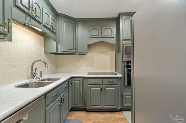 a kitchen with stainless steel appliances granite countertop a sink and cabinets