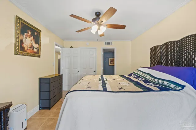 a bedroom with a bed and a ceiling fan