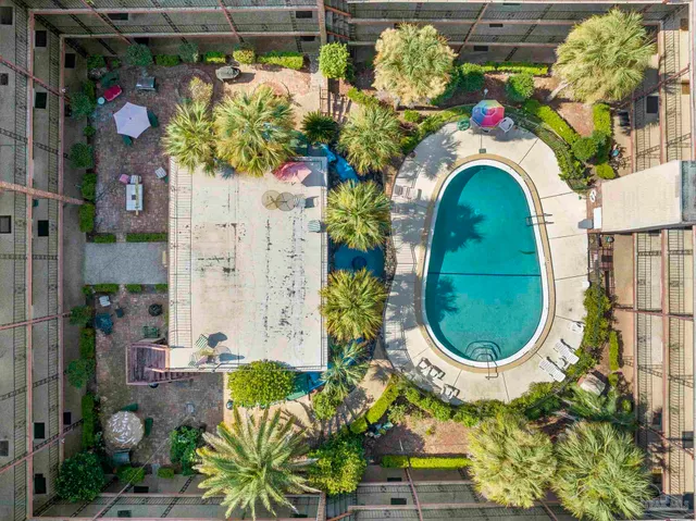a view of a patio with a table and chairs and plants