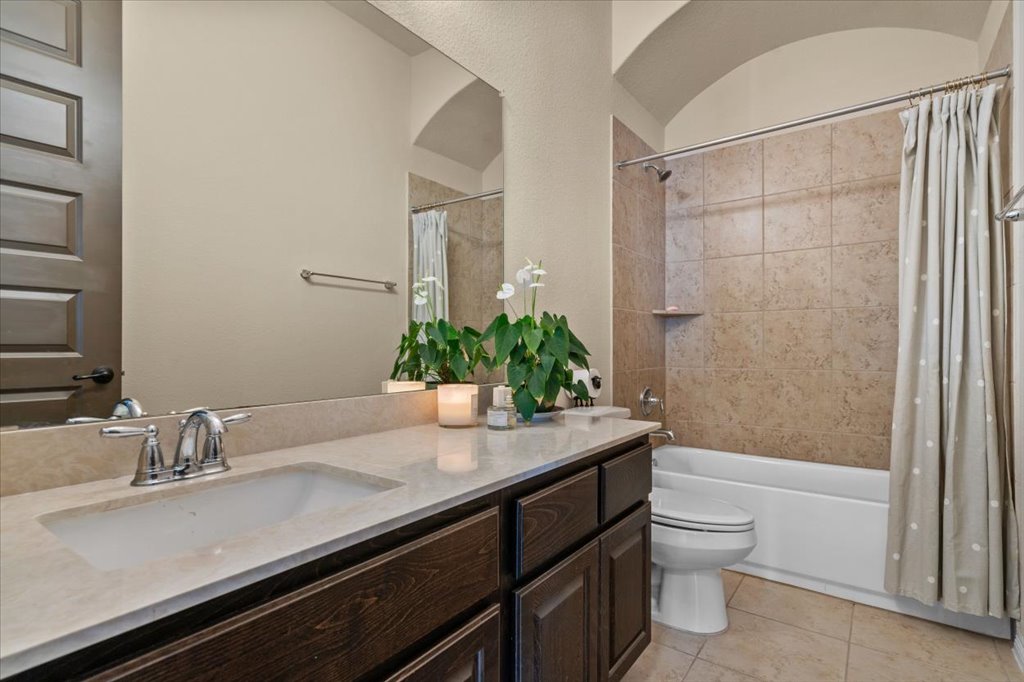 6705 Destination Way Jonestown, TX 78645 - Photo 20 of 39 This secondary bathroom has a large vanity and note the architectural feature above the shower.