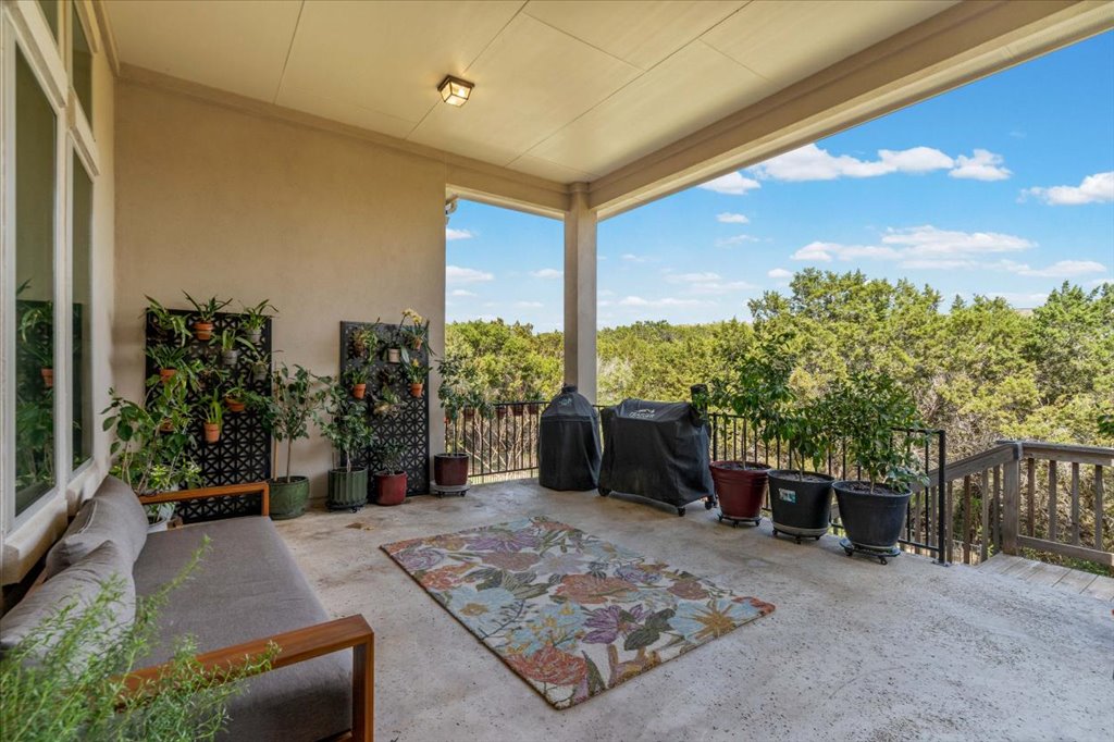 6705 Destination Way Jonestown, TX 78645 - Photo 26 of 39 Step outside to an expansive covered patio that acts as a second living room. Whether you’re tending to your vertical herb garden or grilling against the backdrop of the rolling hills, this space captures the best of the 78645 lifestyle.