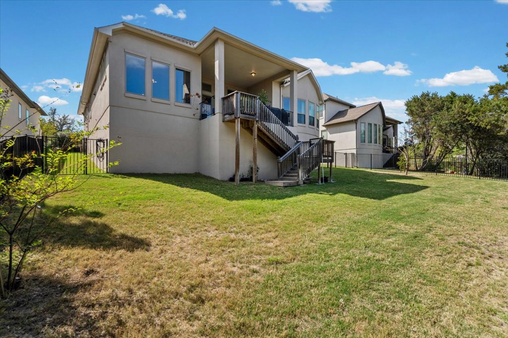 6705 Destination Way Jonestown, TX 78645 - Photo 28 of 39 The rear view of the home showcases its impressive scale and thoughtful design. Multi-level windows and an elevated deck ensure that the stunning views are accessible from almost every room in the house.