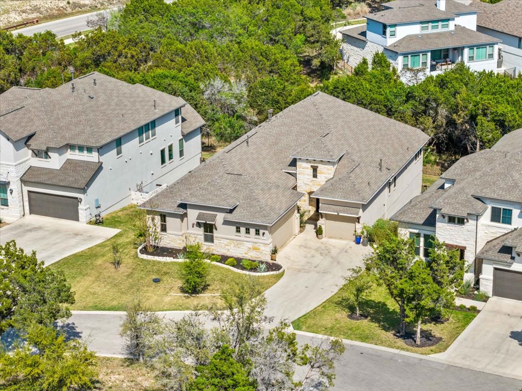 6705 Destination Way Jonestown, TX 78645 - Photo 29 of 39 Nestled on a quiet street with professional landscaping and a stone-accented facade, it’s a standout residence in a premium neighborhood.