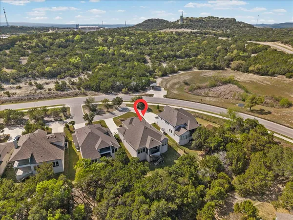 an aerial view of a house with a yard