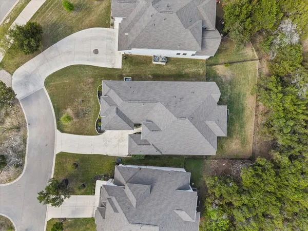an aerial view of residential houses with outdoor space