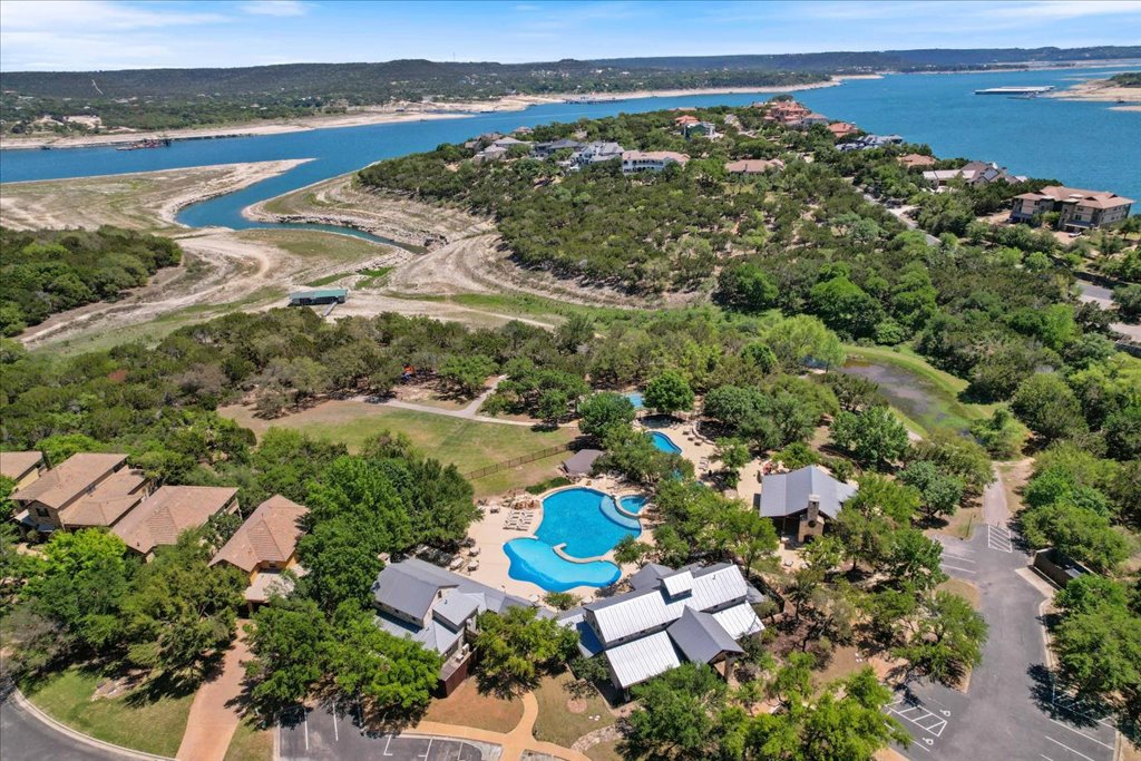 6705 Destination Way Jonestown, TX 78645 - Photo 35 of 39 This stunning aerial captures the sprawling community aquatic center, featuring a lagoon-style pool that overlooks the winding inlets of Lake Travis. It’s the centerpiece of a community designed for those who love the outdoors.