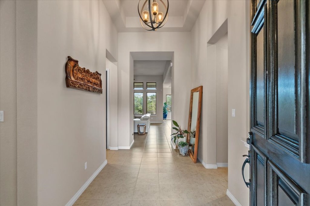 6705 Destination Way Jonestown, TX 78645 - Photo 5 of 39 Make a grand entrance. This wide, sun-drenched foyer features towering ceilings and a direct sightline that draws you right into the heart of the home.