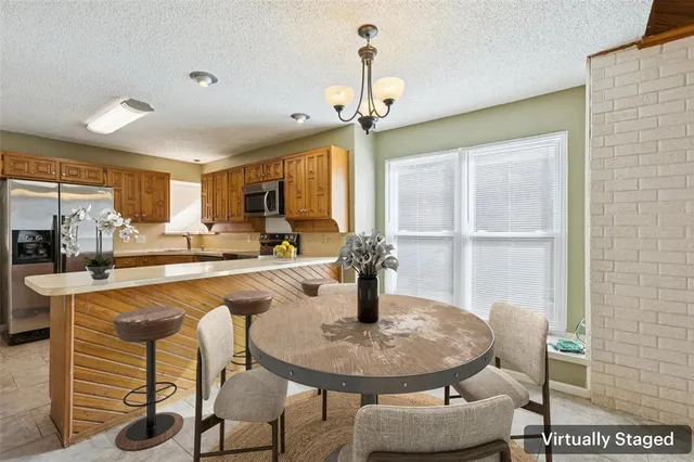 a dining room with furniture and a chandelier