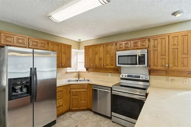 a kitchen with a refrigerator stove and sink