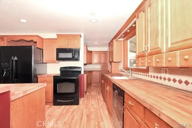 a kitchen with stainless steel appliances granite countertop a sink and a stove