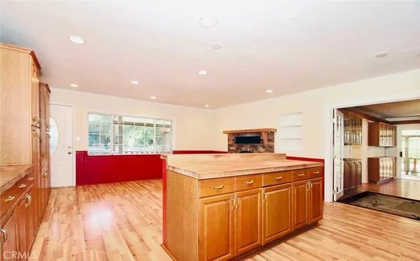 a room with stainless steel appliances kitchen island granite countertop a stove a sink and a refrigerator