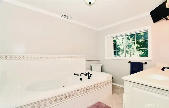 a bathroom with a bathtub and a window