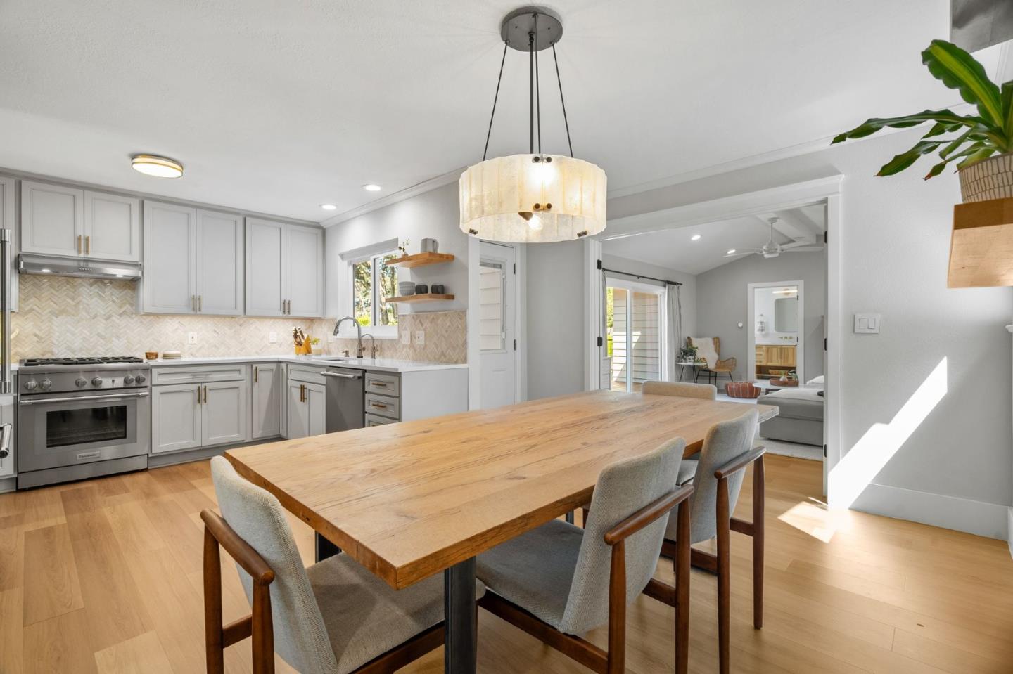1085 Barcelona Drive Pacifica, CA 94044 - Photo 14 of 55 a kitchen with a dining table chairs stainless steel appliances and cabinets