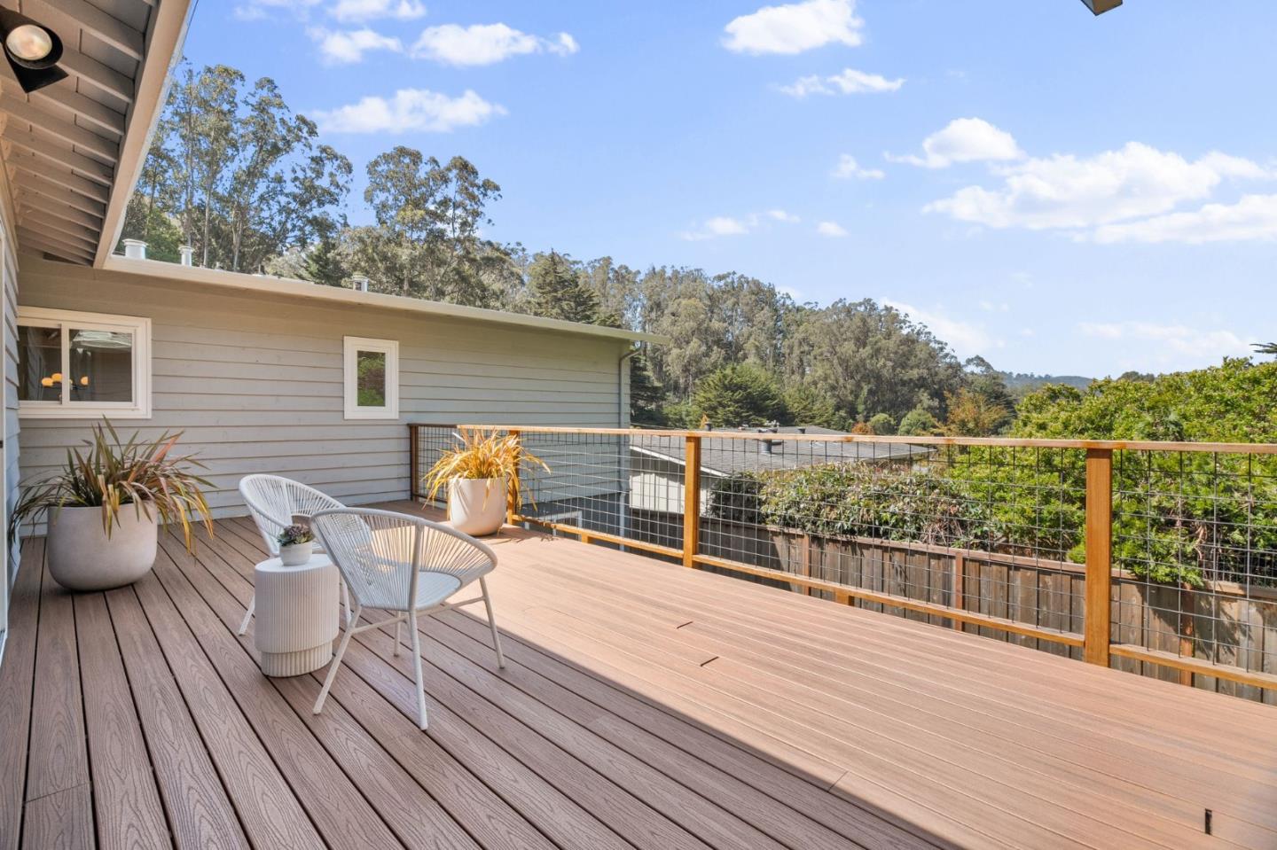 1085 Barcelona Drive Pacifica, CA 94044 - Photo 17 of 55 a view of a roof deck with table and chairs a barbeque with wooden floor and fence