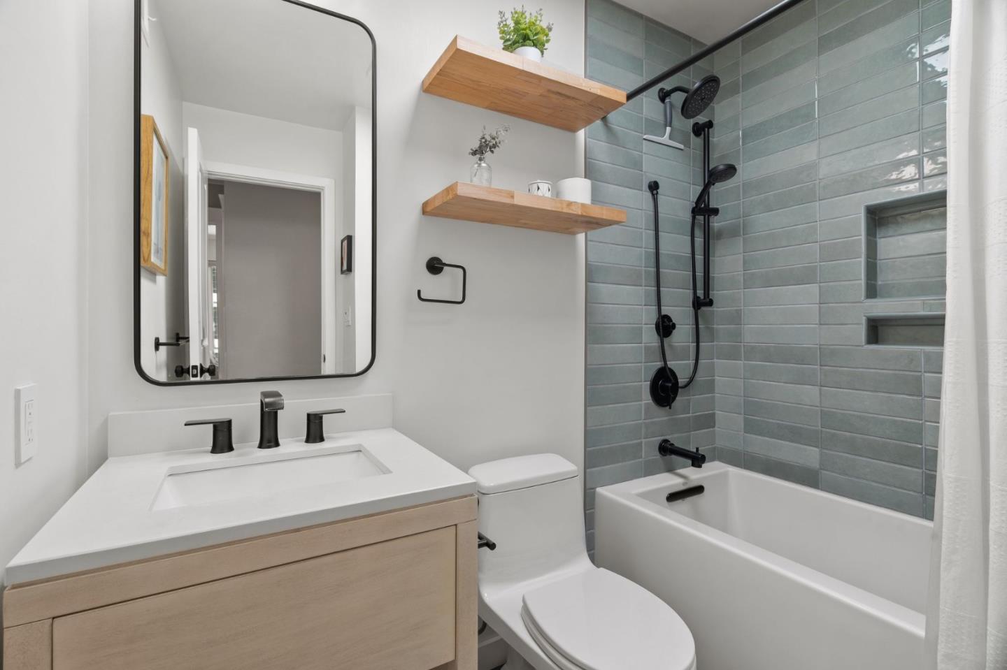 1085 Barcelona Drive Pacifica, CA 94044 - Photo 27 of 55 a bathroom with a toilet sink vanity tub and shower