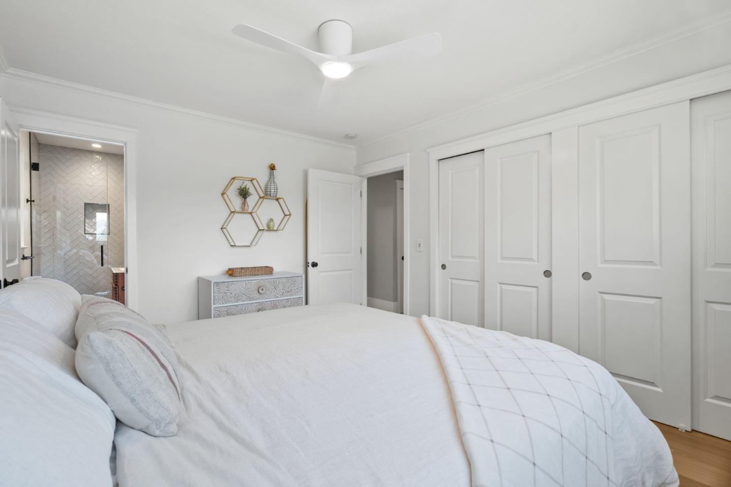 1085 Barcelona Drive Pacifica, CA 94044 - Photo 29 of 55 a bedroom with a bed and a chandelier