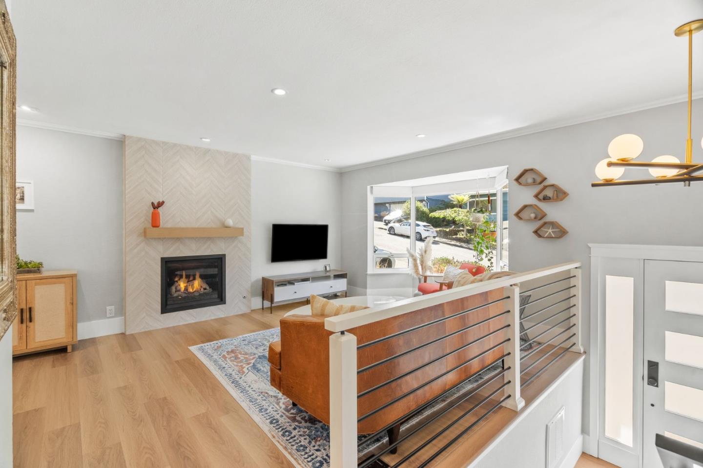 1085 Barcelona Drive Pacifica, CA 94044 - Photo 3 of 55 a living room with furniture a fireplace and a flat screen tv