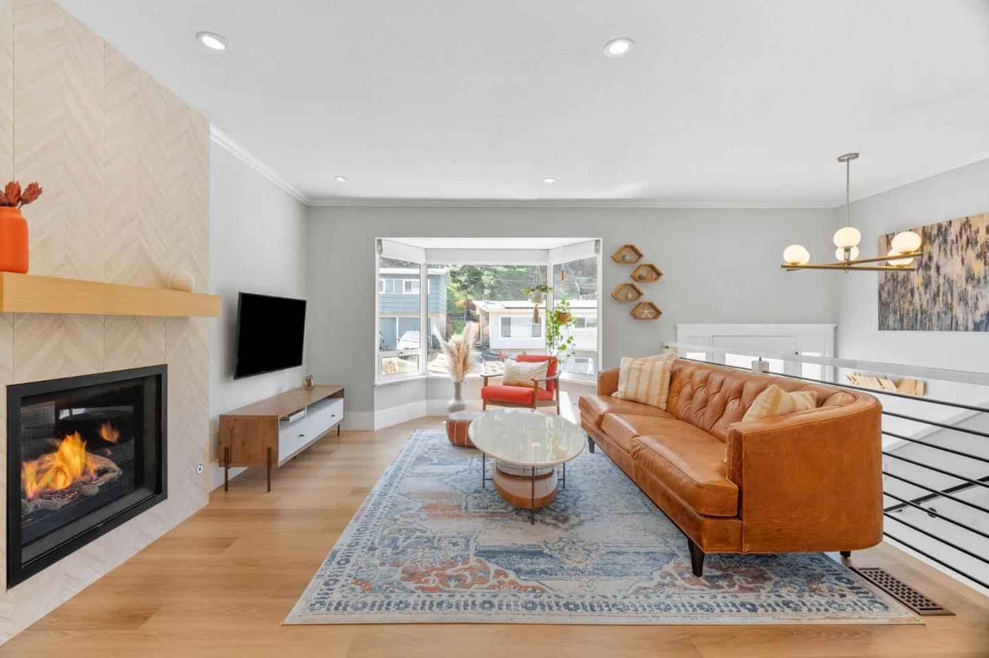 1085 Barcelona Drive Pacifica, CA 94044 - Photo 6 of 55 a living room with furniture a flat screen tv and a fireplace