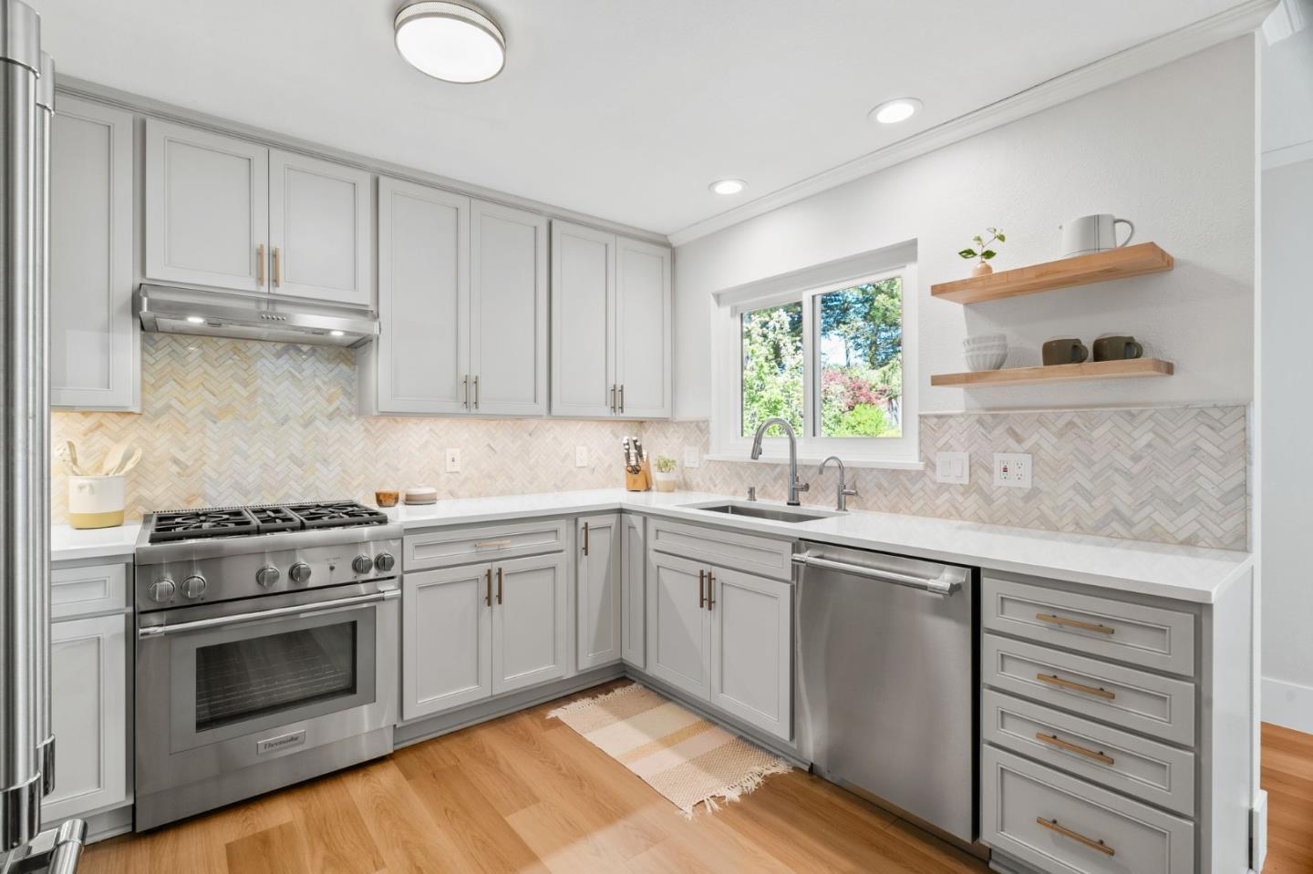 1085 Barcelona Drive Pacifica, CA 94044 - Photo 7 of 55 a kitchen with cabinets stainless steel appliances and a sink
