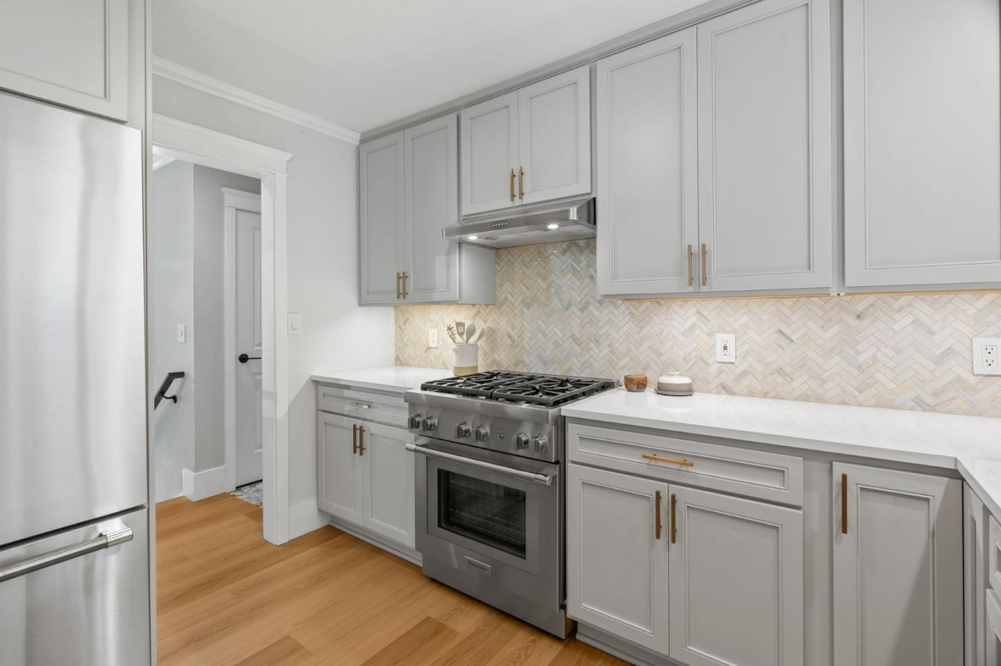 1085 Barcelona Drive Pacifica, CA 94044 - Photo 9 of 55 a kitchen with white cabinets and white appliances