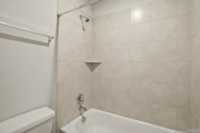 a bathroom with a bathtub and a toilet