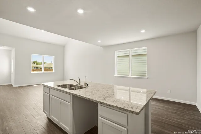 a kitchen that has a sink and a stove in it