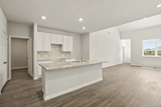 a kitchen with stainless steel appliances granite countertop a sink and cabinets
