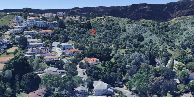 an aerial view of residential house and sandy dunes